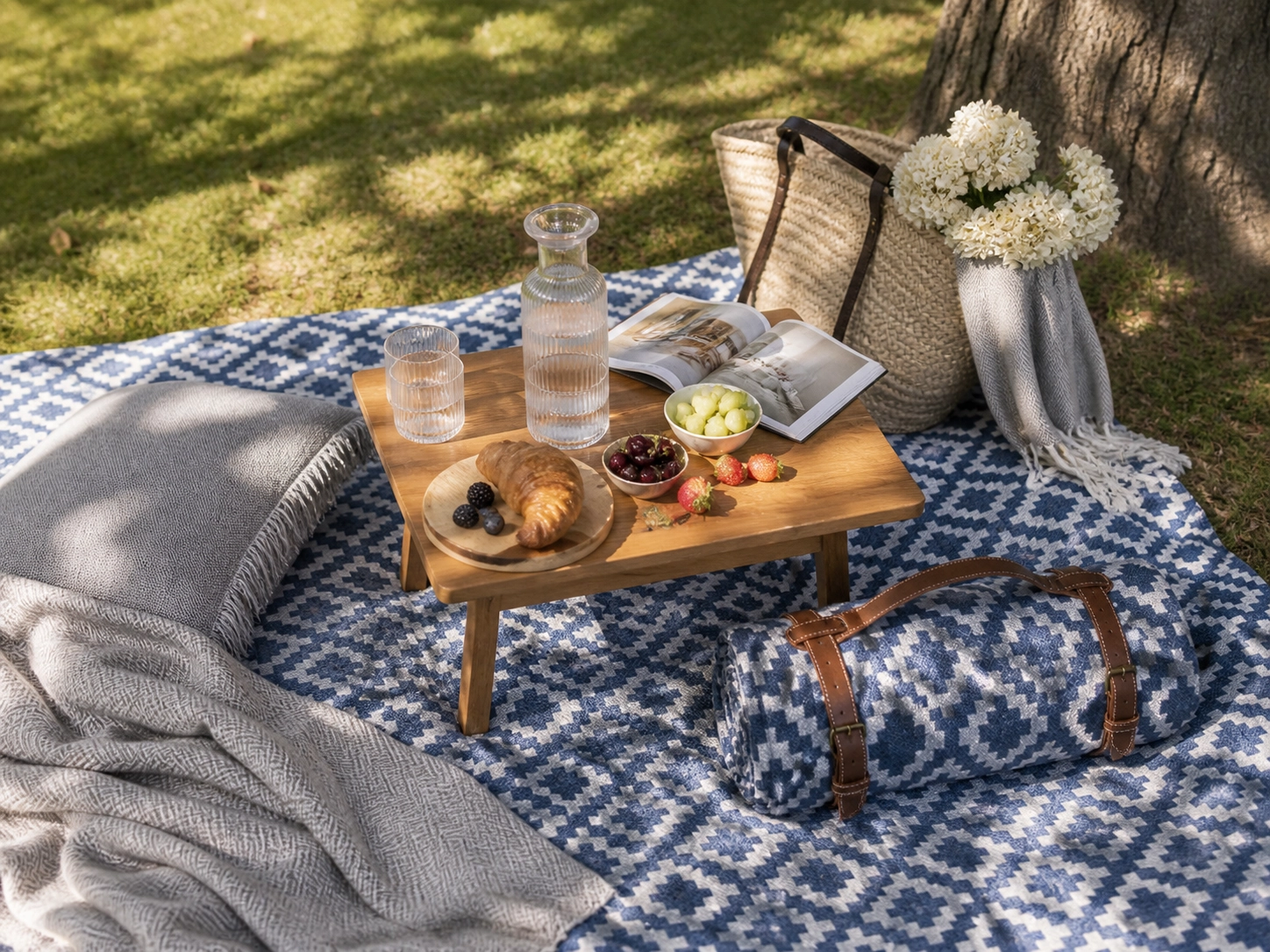 Stylish picnic blanket with outdoor accessories arranged for a relaxed park picnic.
