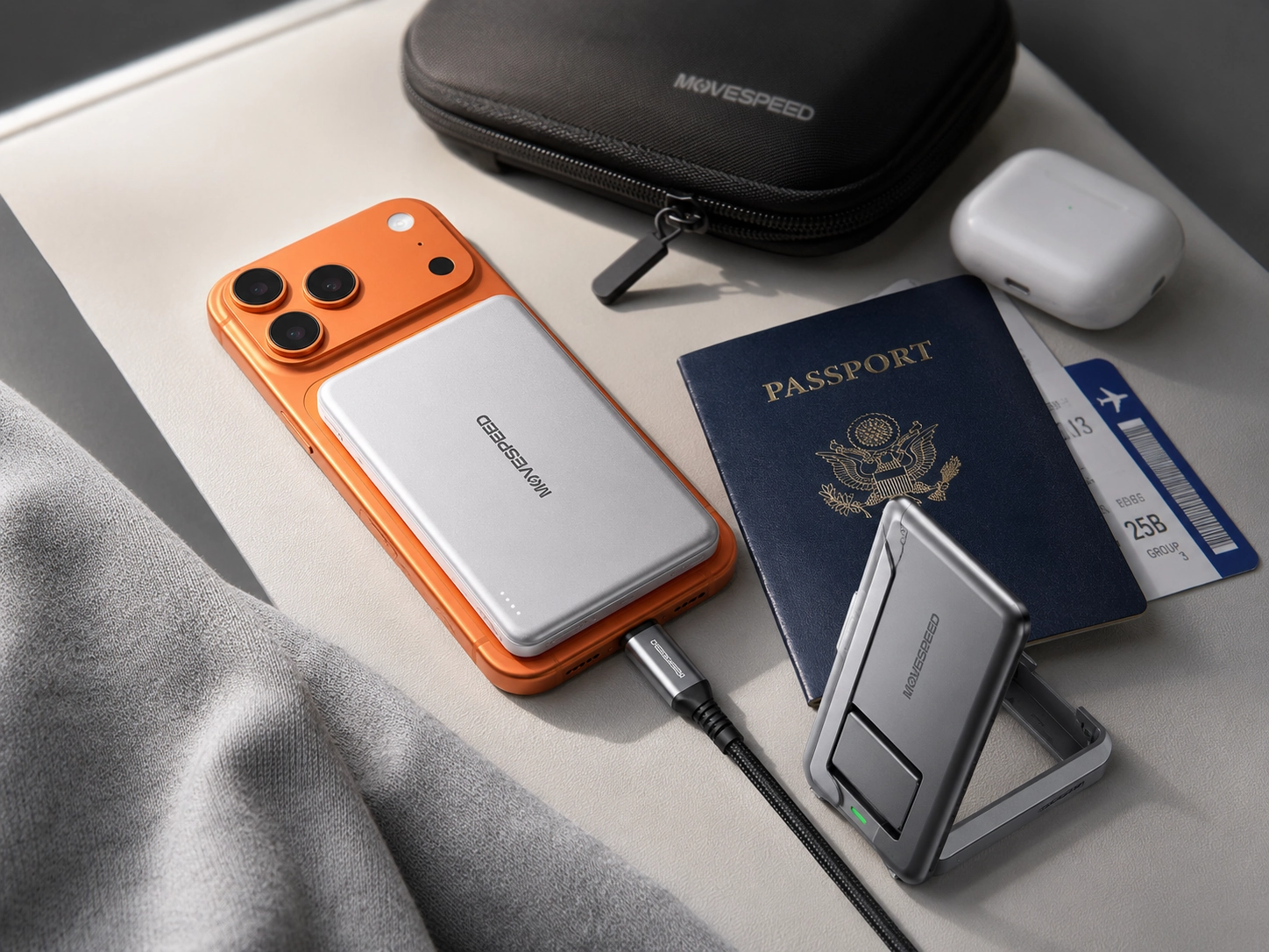 MOVESPEED-style travel charging setup with magnetic power bank, high-capacity power bank, USB-C cable, passport, earbuds, and Memorial Day travel essentials.