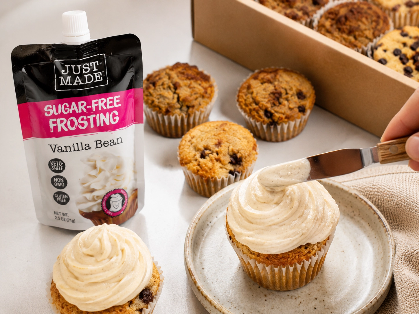 Sugar-free frosting being spread on muffins for a better-for-you cupcake-style dessert.