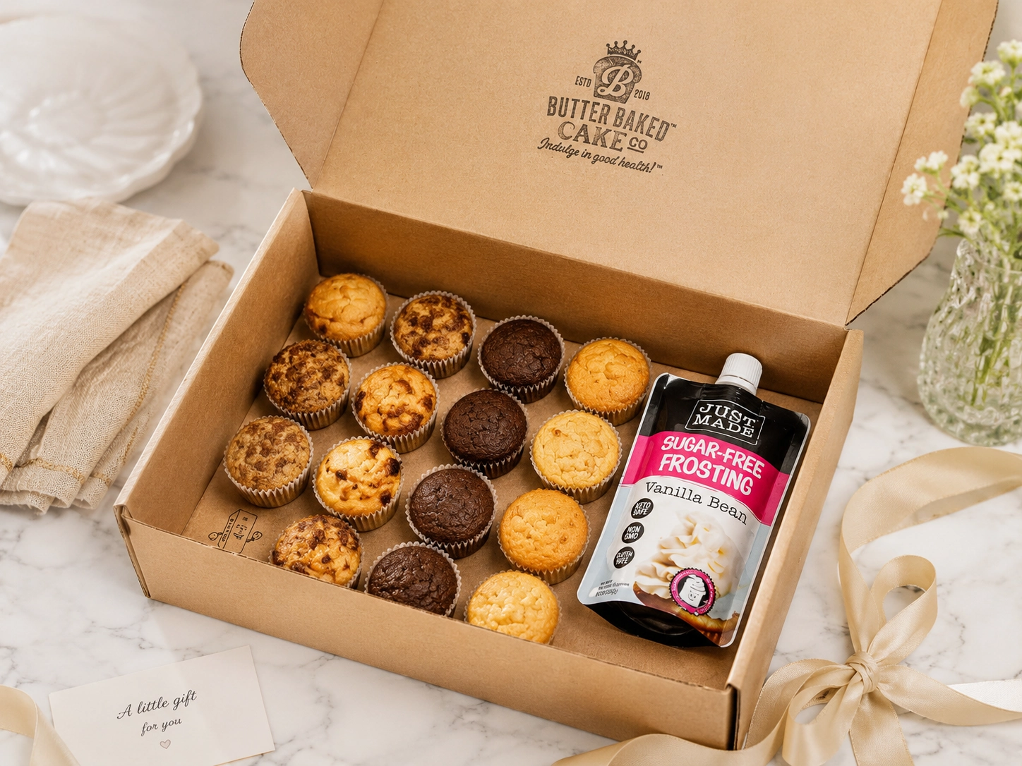 Butter Baked Cake Co-style dessert box with muffins and sugar-free frosting prepared as a gift.